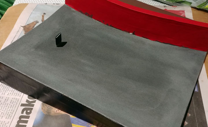 Painting the sandpaper to look like a road surface