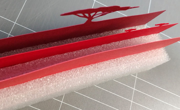 Three layers of ground elements are separated with packing foam to create depth